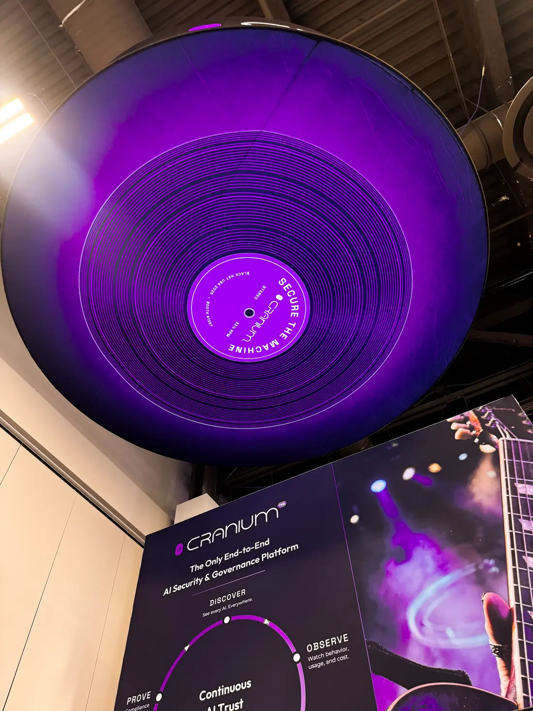 The violet pressing of &ldquo;Secure the Machine&rdquo; against the booth panel